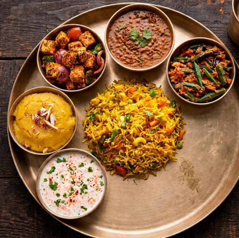 Tandoori Paneer Thali with Daal Makhni, Bhindi Masala, Veg Pulao, Mung Daal Halwa, Raita of the Day